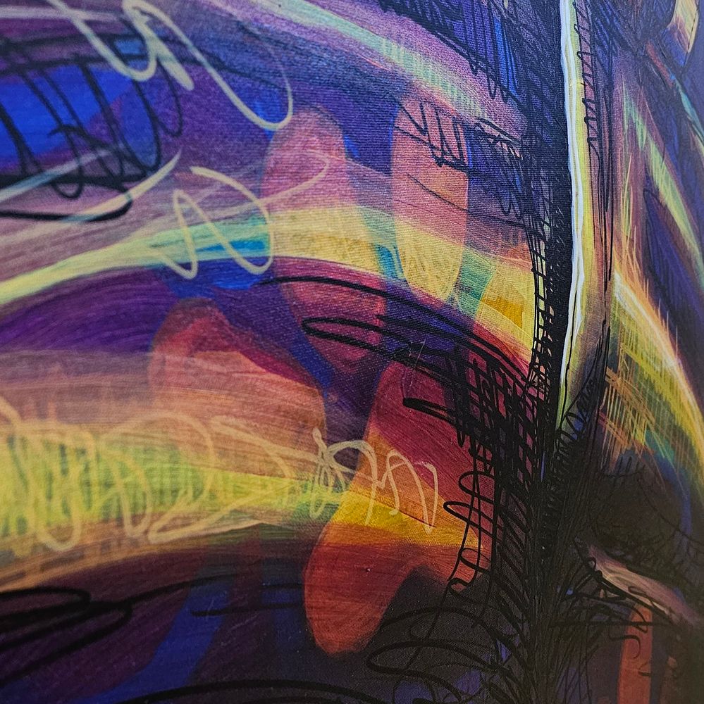 Blue, orange, red, yellow close up of a painting, with paw prints on a pair of jeans.