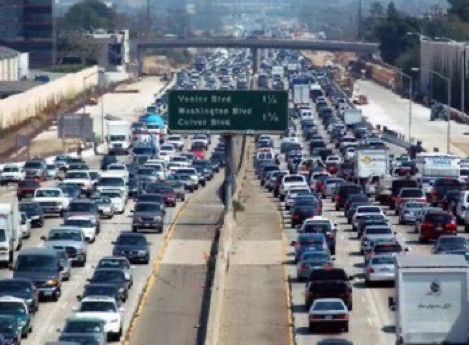 Images of freeways with many lanes filled with car traffic that will never be solved by adding more lanes