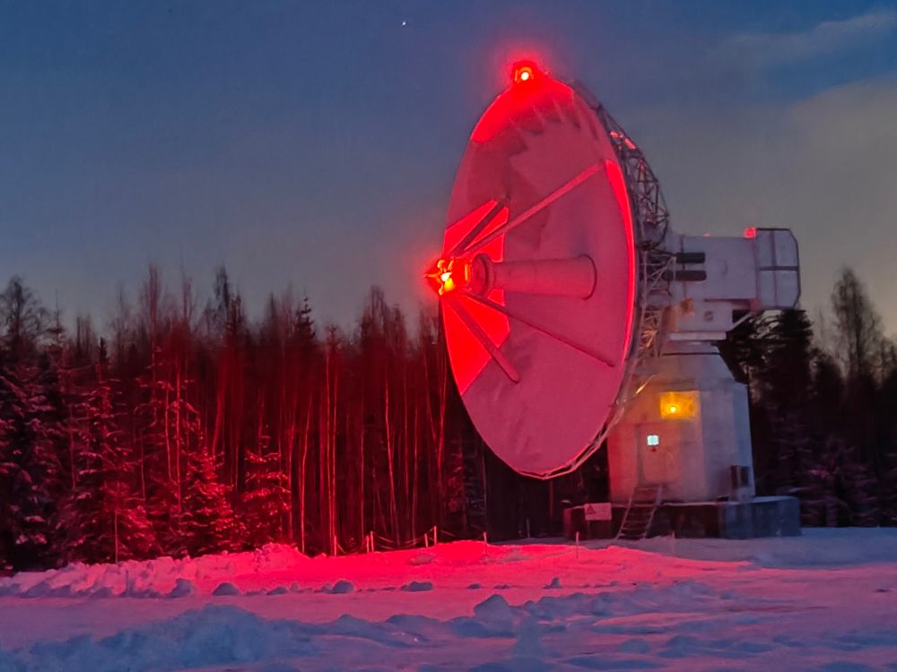 Radiotelescope in Red light that reflects from snow