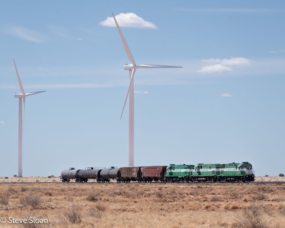 APA train at Wind Farm
At 10:15 a.m. on Thursday, May 1, 2025, Apache Railway Company (APA) 99 is leading a 3+0 power set on a very short train at the Dry Lake Wind Power Project at Sugarloaf Rd. north of Snowflake, AZ. The power set is APA 99, 81, 98.
APA 99 is an ALCo/MLW C424.
Reportedly: It was built in 1965, serial number 3436-011, as CP 4233.