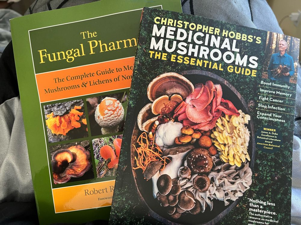 Image description: a photo of two books on the topic of medicinal mushrooms. One book is entitled, “Fungal Pharmacy”, and the other is entitled, “Medicinal Mushrooms – The Essential Guide”.
