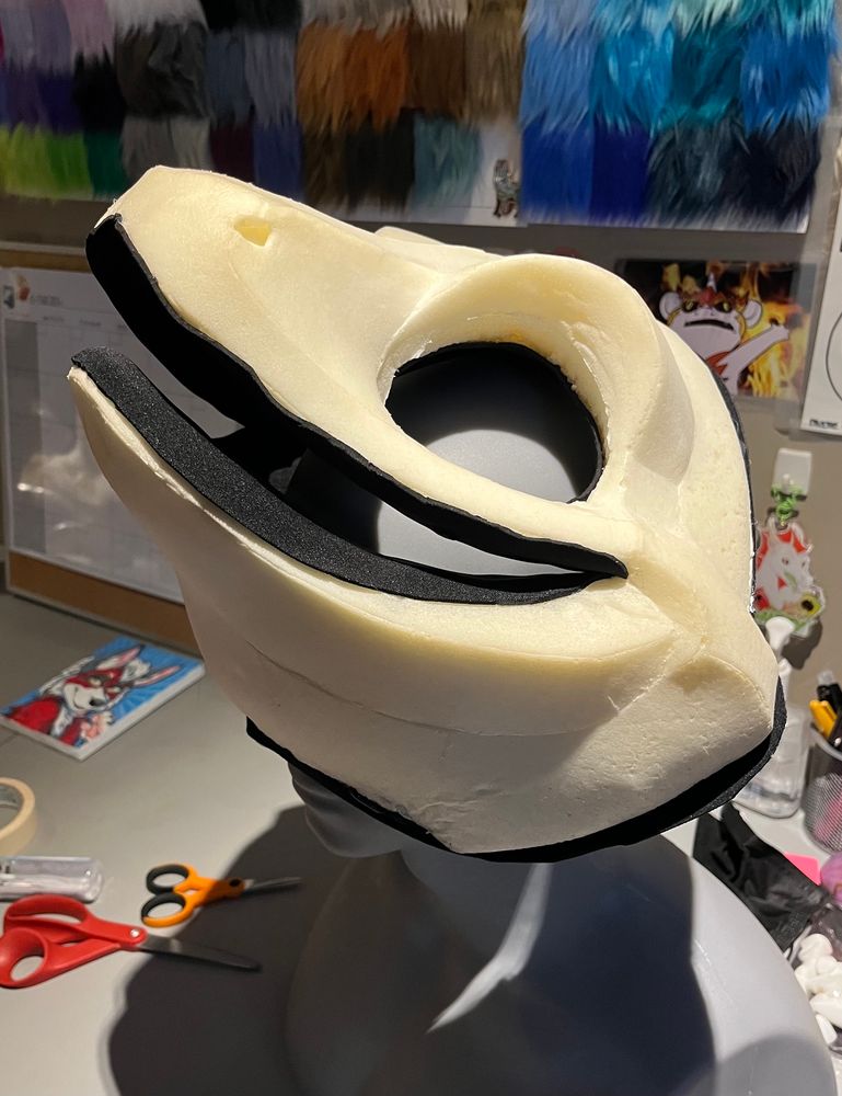 Side profile of foam gecko fursuit headbase on mannequin. 