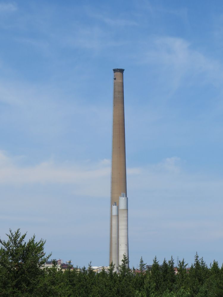 The INCO Superstack, once the world’s tallest chimney, is slowly being dismantled from the top; two new cleaner-burning smelter stacks are below. 