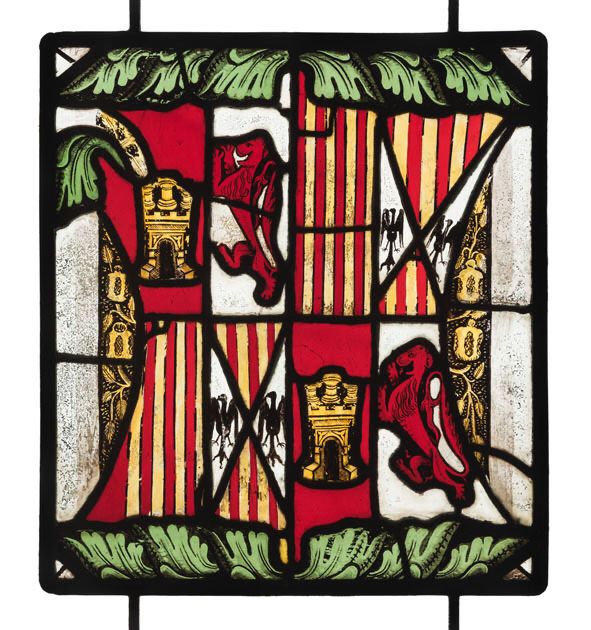 A stained glass panel with the shields of Castile (a gold castle on a red ground) and León (a red lion on a white ground) quartering Aragon (gold and red vertical stripes) and Sicily (black eagles on a white ground). Either side has pomegranates in the side segments were the emblem of Catherine of Aragon with green leaves along the top and bottom.
