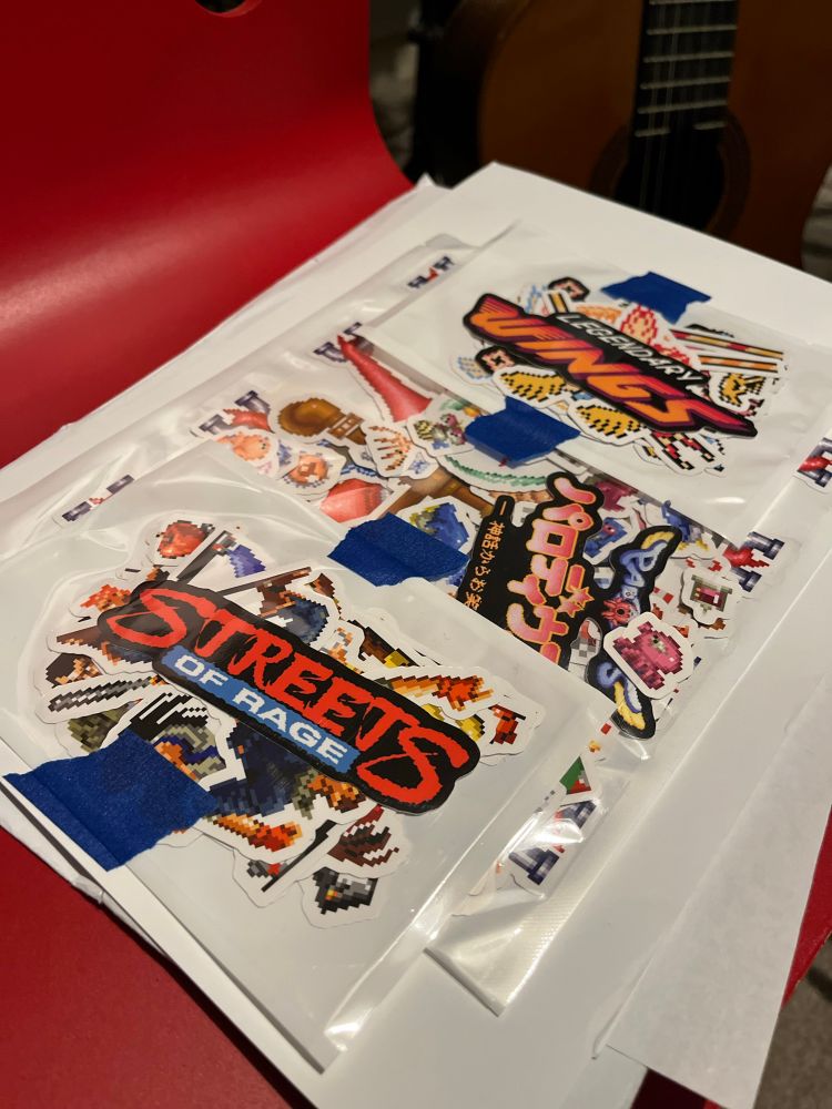 Packaged sticker sets of art work & sprites from Parodius, Streets of Rage & Legendary Wings.