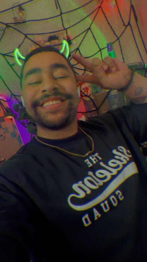Green horns in the Skeleton squad long sleeve holding up a peace sign 