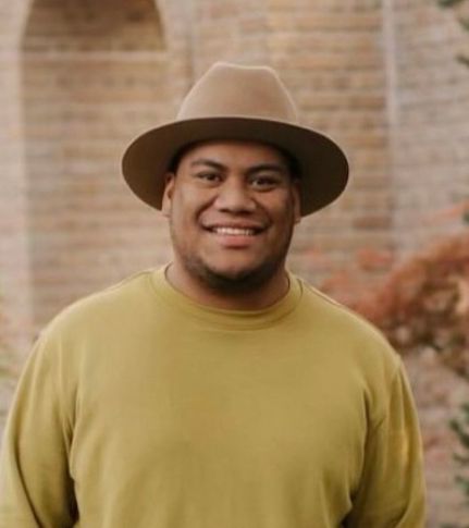A handsome Samoan American man smiling
