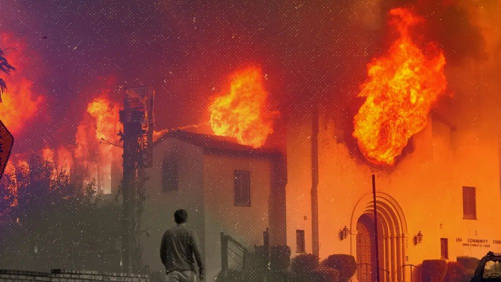 A person walks in front of a burning church in Pasadena, California, on Jan. 8, 2025. Huge fountains of flame are shooting out of the windows AP Photo/Chris Pizzello)