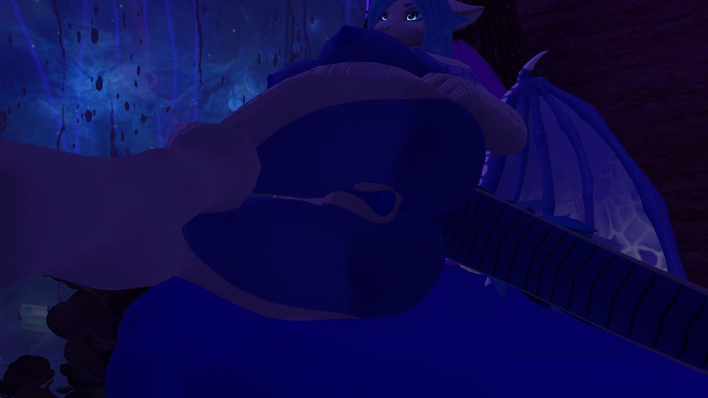 A blue and white dragon laying on their side exposing their holes. 