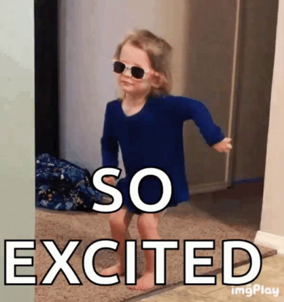 a little girl wearing sunglasses and a blue shirt is excited