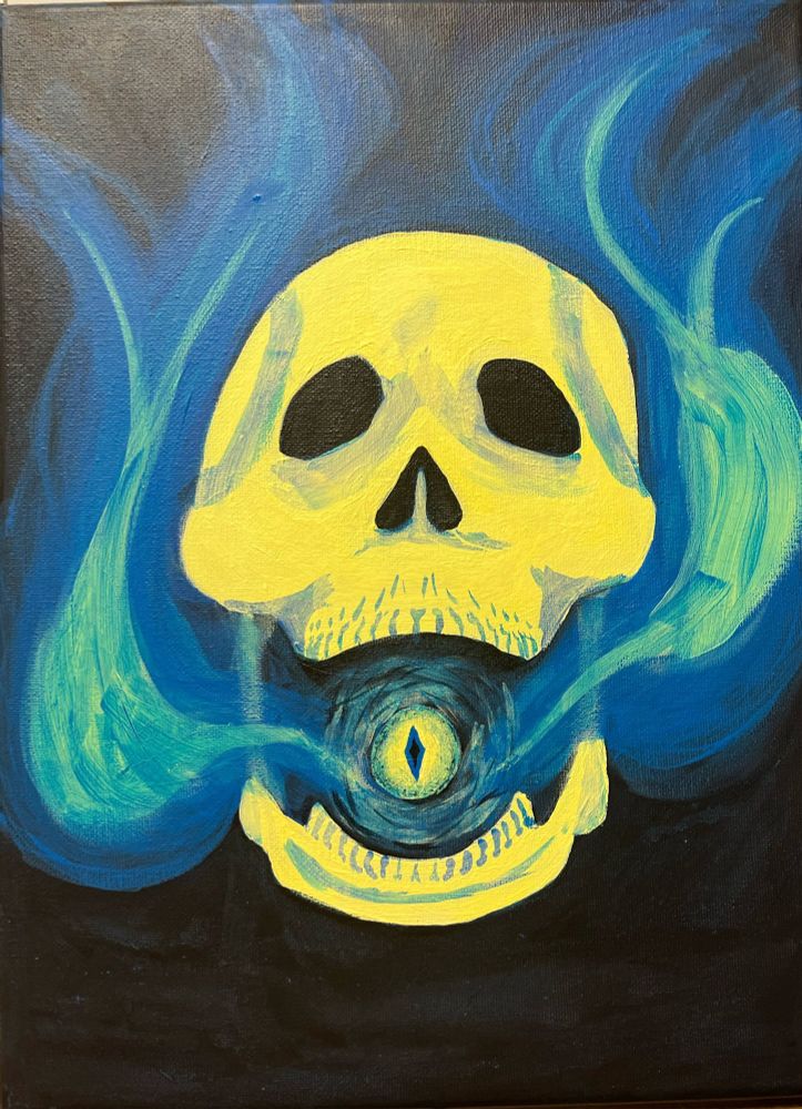 Screaming skull with blue flames pouring out of its mouth and a spooky reptilian eye ball in the mouth as well.