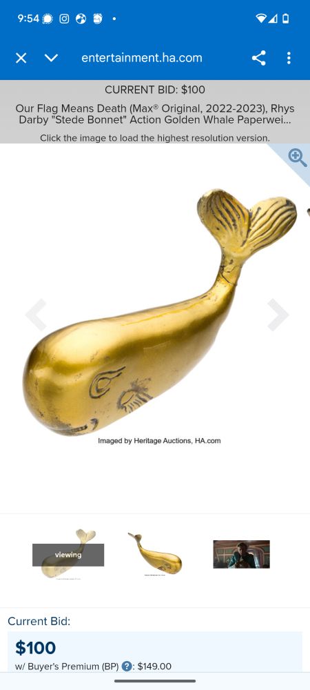 A brass whale paperweight on an auction site 