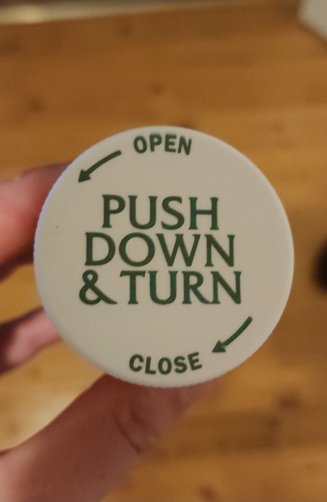 It's the lid of a pill bottle that says "push down and turn". It's the same font as the Law and Order TV series wordmark