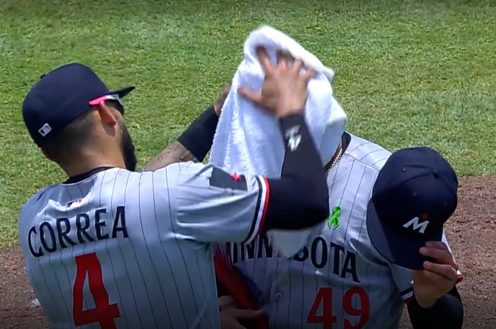 Carlos Correa towels off Pablo Lopez' head