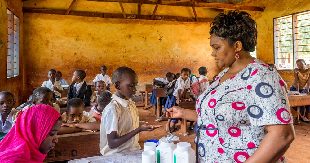 Children receive deworming drugs at a school in Tanzania. Picture credit: Louise Gubb/RTI Fights NTDs