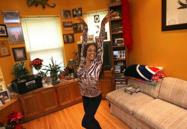 Luci Collins Black gymnast poses with her arms in the air. She’s wearing a zebra print shirt and black pants. 