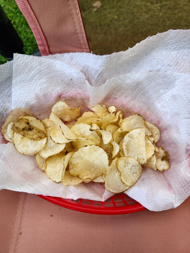 Fresh homemade potato chips cooked over an open fire 