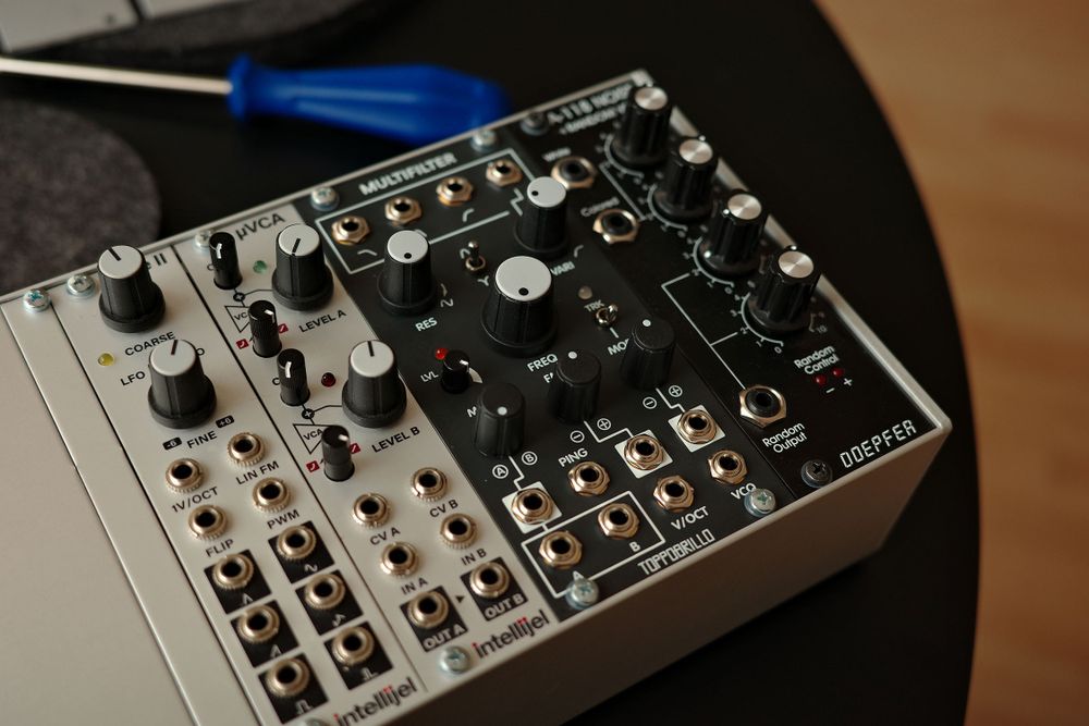 Photograph of a portion of a silver modular synthesizer rack with the aforementioned Toppobrillo Multifilter 2 module (black version) installed.