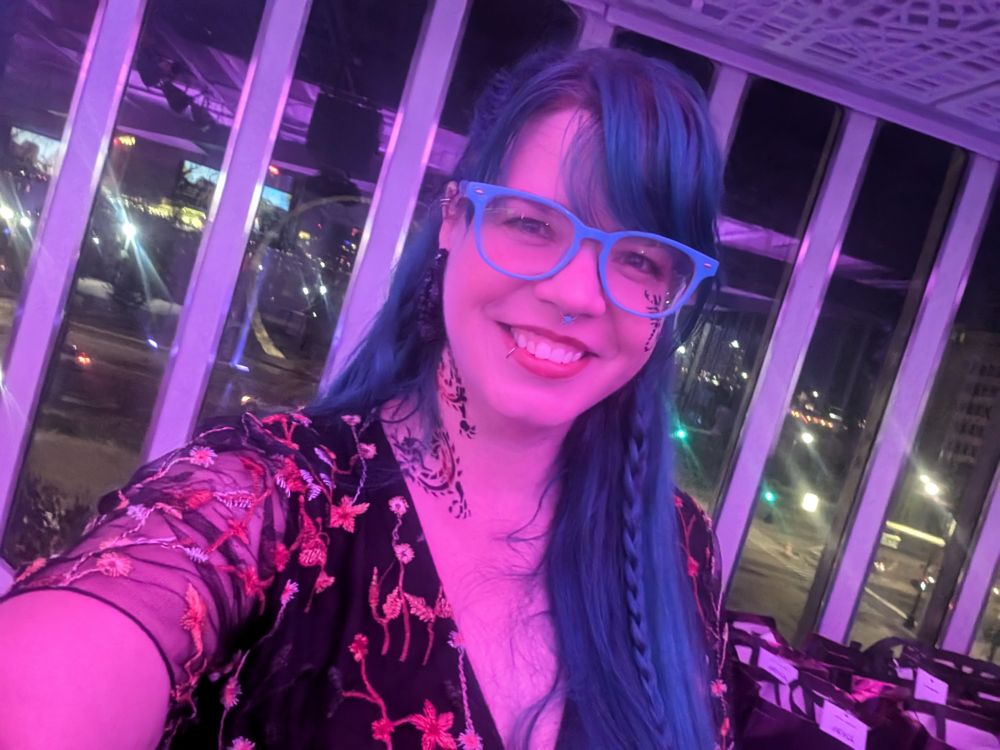 Me at a party with my neck and face tattoos 