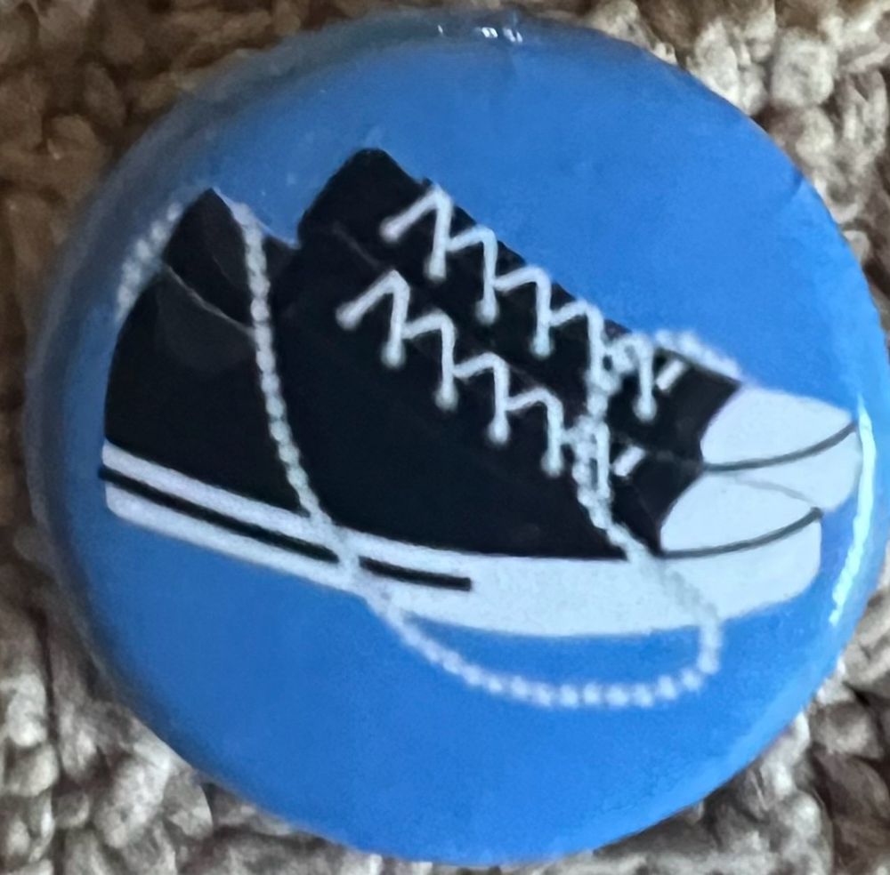 Blue Pin w/black  converse gym shoes and pearls - often used to depict her signature style while she was in the US Senate.