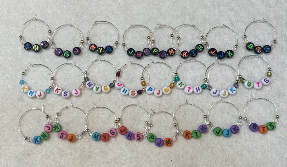 Three sets of wine charms with BTS initials in fan chant order 