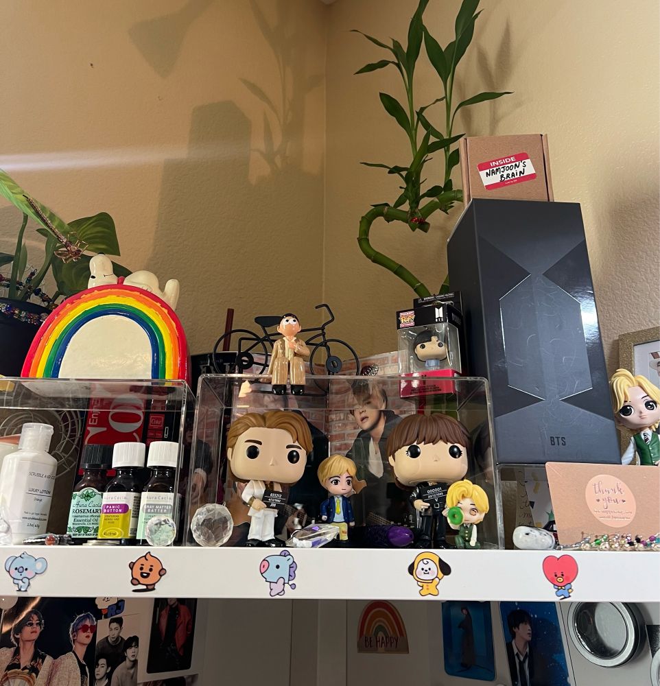 Picture of BTS figurines and other ass’t merch on a personal office shelf, featuring a Namjoon figuring from his Lost! MV