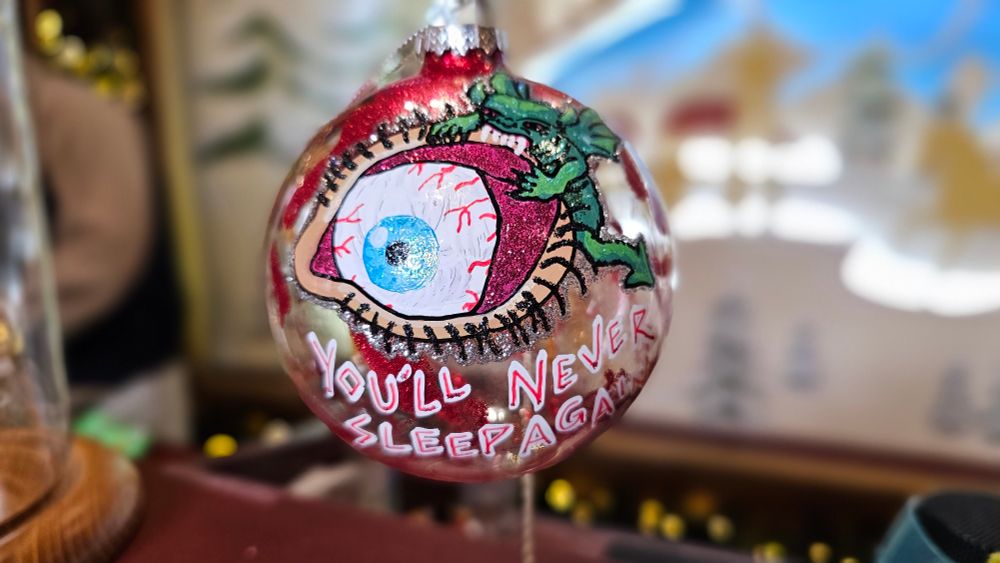 Personalized Holiday Ornament featuring Halloween Horror Nights 1997 Frightmares Artwork of Demon Biting Eyelid. Universal Studios in Orlando, Florida Merchandise Shopping Service hedgehogscorner.com