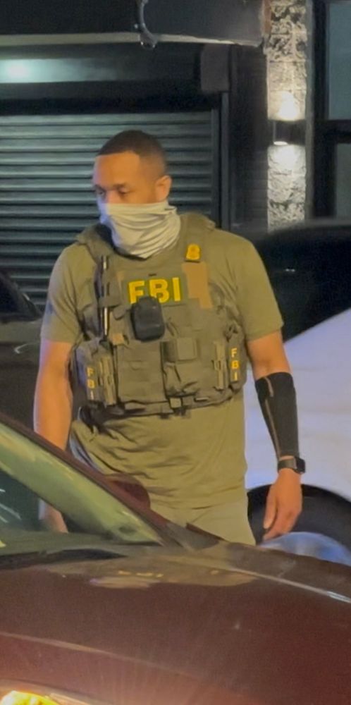 FBI agent being a coward and covering their face during a traffic stop.