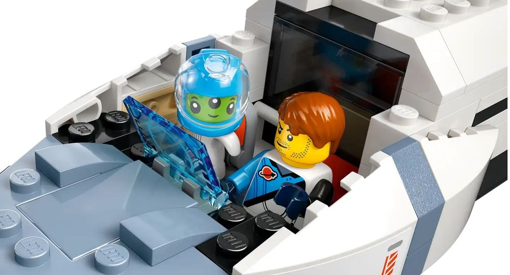 Now inside the spaceship, the minifig astronaut has hair instead of a helmet, but the alien astronaut has a helmet