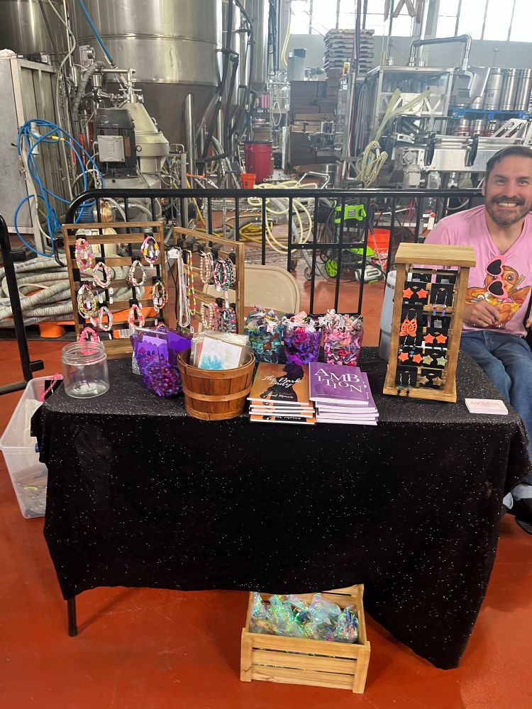 Bracelets, books, postcards, hair ties, necklaces, and earrings for sale. Husband is not for sale. 