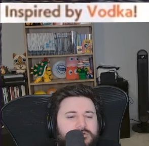 Barry sitting low in his chair so it is just his face in the lower third of the picture with a caption on top saying Inspired by Vodka