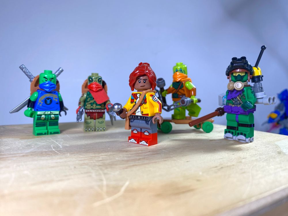 I made the turtles all different shades of green, the only think I’m not really satisfied with is Donnie’s face mask thing, but I guess out of all of them it works for him the best.

Leo’s design is fairly standard, I just used the dual molded arms to give him some arm braces, and the one black hand is intentional.

Raph has a more crocodilian design, I cannot take credit for the idea though, but I don’t remember who came up with it initially.

April’s design is one that mixes a bunch of ideas I had, mostly taking inspiration from her Mutant Mayhem design.

Mikey has a smaller shell using a flipped life preserver (thanks Evelynn for the suggestion!) and arm braces as well, they were the first part I though of using and the rest fell into place after that.

Donnie’s design I touched on before, but I went for a more tech-based approach, including a Pip-Boy inspired wrist device. The green goblin torso works great, (credit to psycho.figs on instagram for the original idea) especially since I don’t have a purple ninja mask.