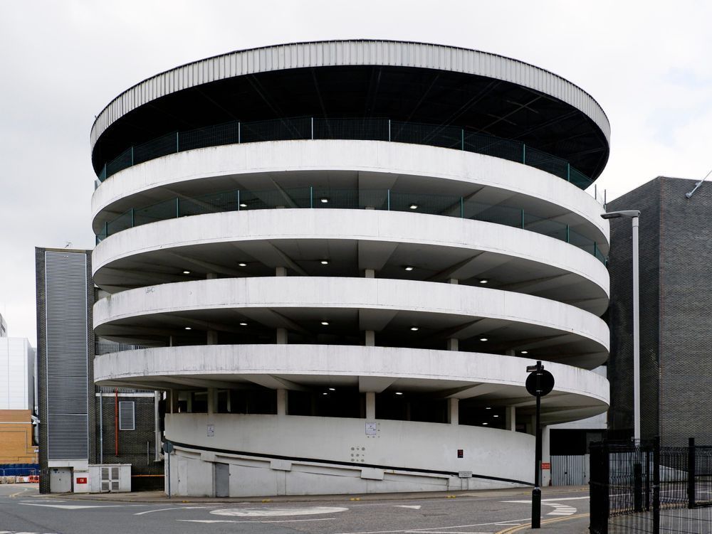 A colour photograph of a concrete spiral ramp car park in Romford