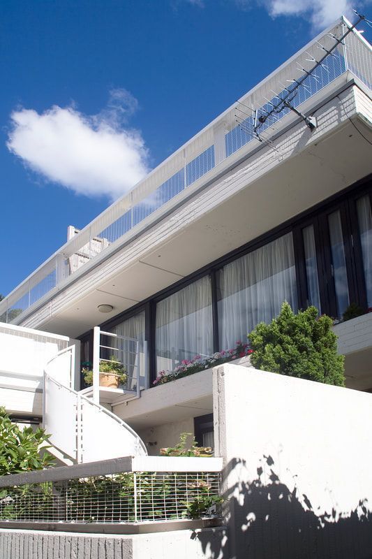 A colour photograph of a home on the Branch Hill estate in white painted concrete