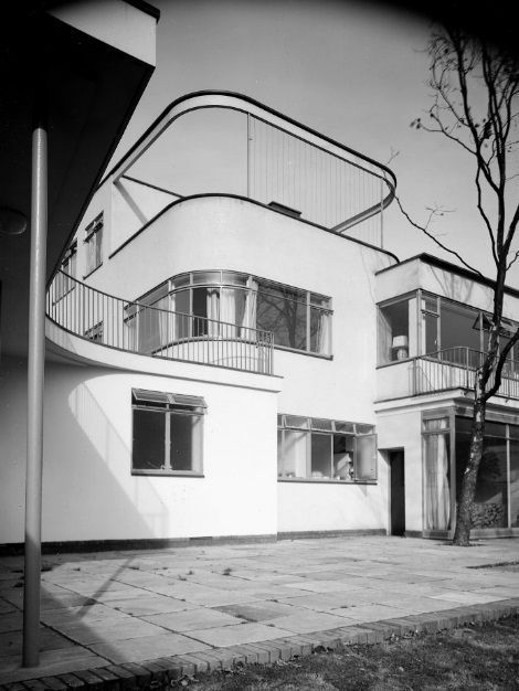 A black and white photograph of 66 Old Church Street as seen from the garden, with its open terraces