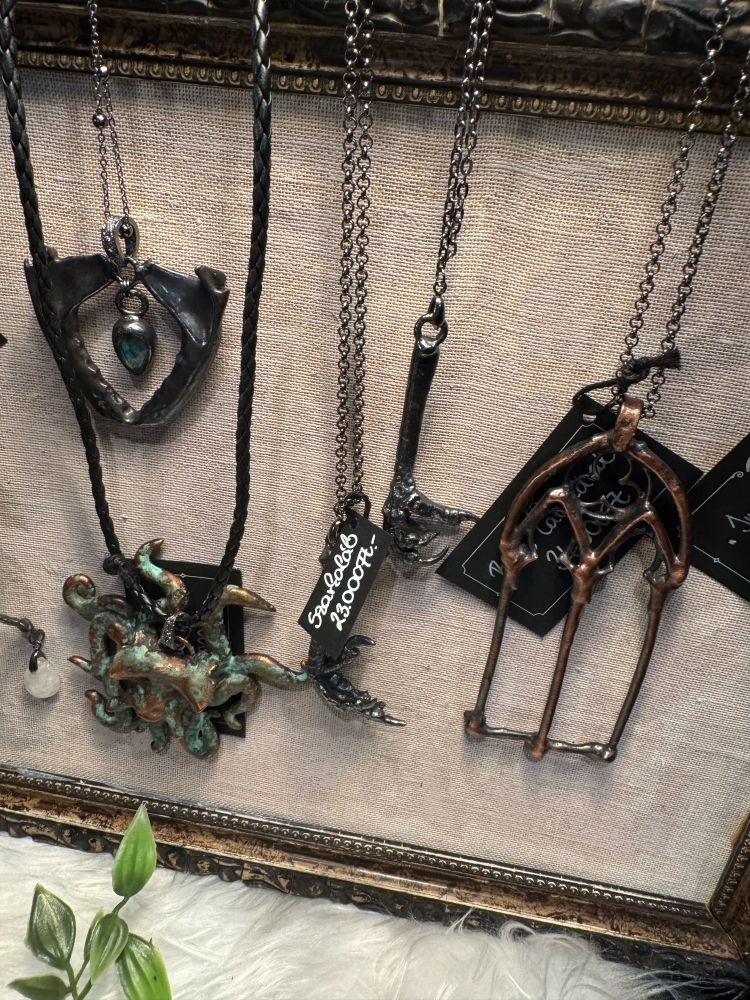 Multiple medallions made out of bones with copper plating