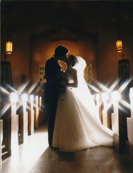 Newly married couple in the aisle of a church immediately after the wedding.