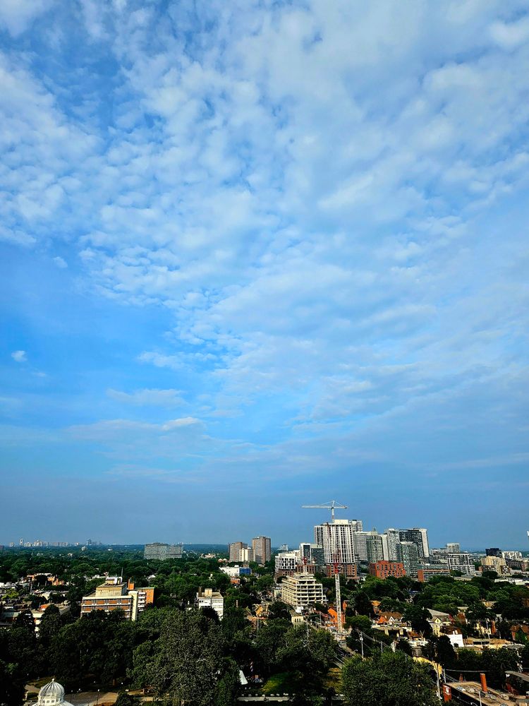 Fluffy clouds blue skies in downtown Toronto 
