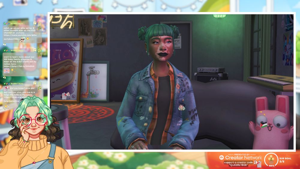 pastel background art not seen much behind the chat bubbles, ea creator network logo, sub goal tracker, captions etc. the main things shown are my pngtuber smiling in the lefthand corner and the sim which is a tan asian sim feminine sim with vitiligo, green space buns, black lipstick and a denim jacket with writing and patches in a grungy looking house.