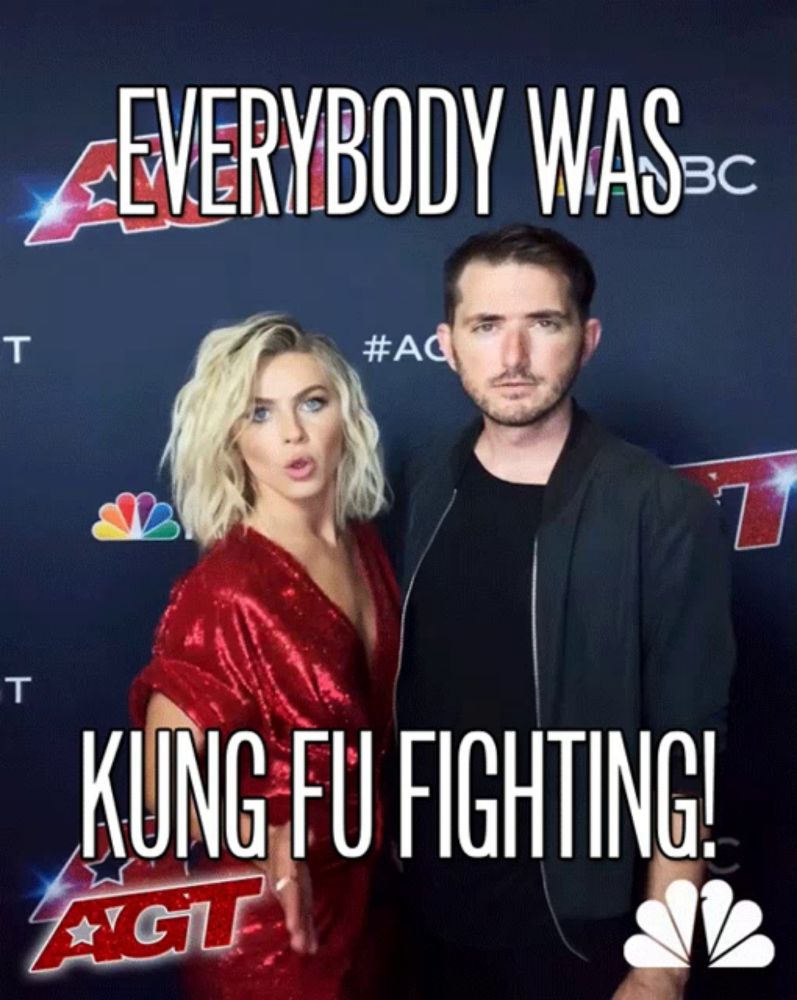 a man and a woman standing next to each other on a red carpet that says kung fu fighting