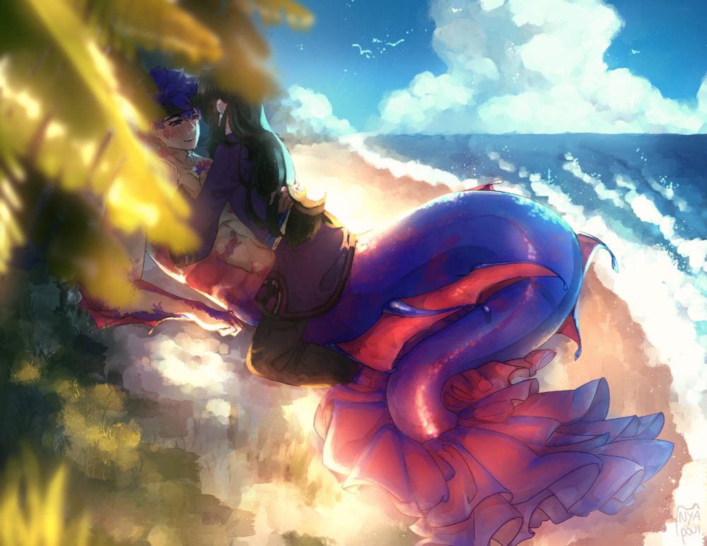 Ike and Soren (sitting on Ike) sitting on a beach with green grass and leaves to the left and a big cloud in the open sky above a blue ocean on the right