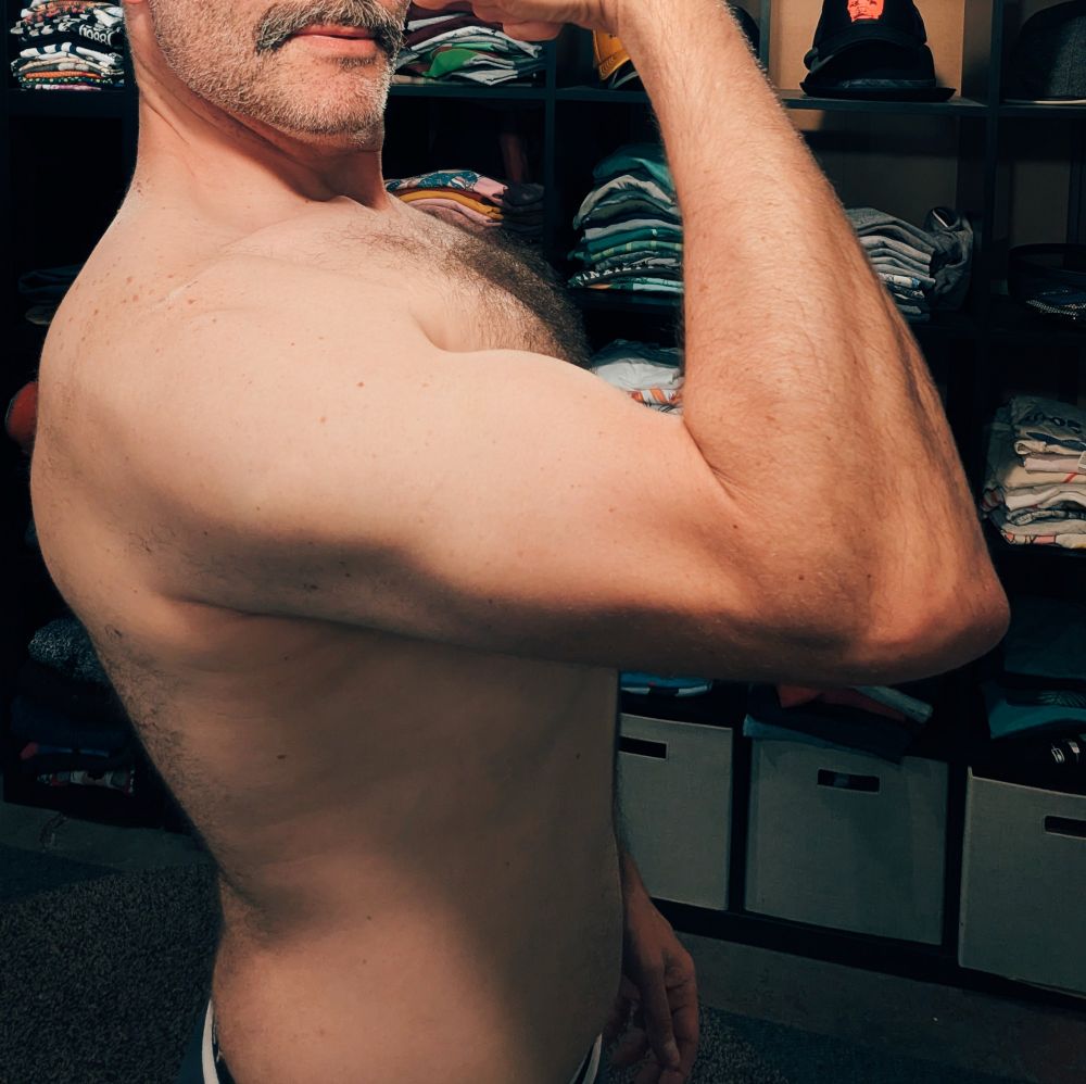 Cropped at waist and below my nose, I'm flexing in this pic to emphasize some arm definition. But I believe the focus is stolen by my hairy pecs peaking above my bicep.