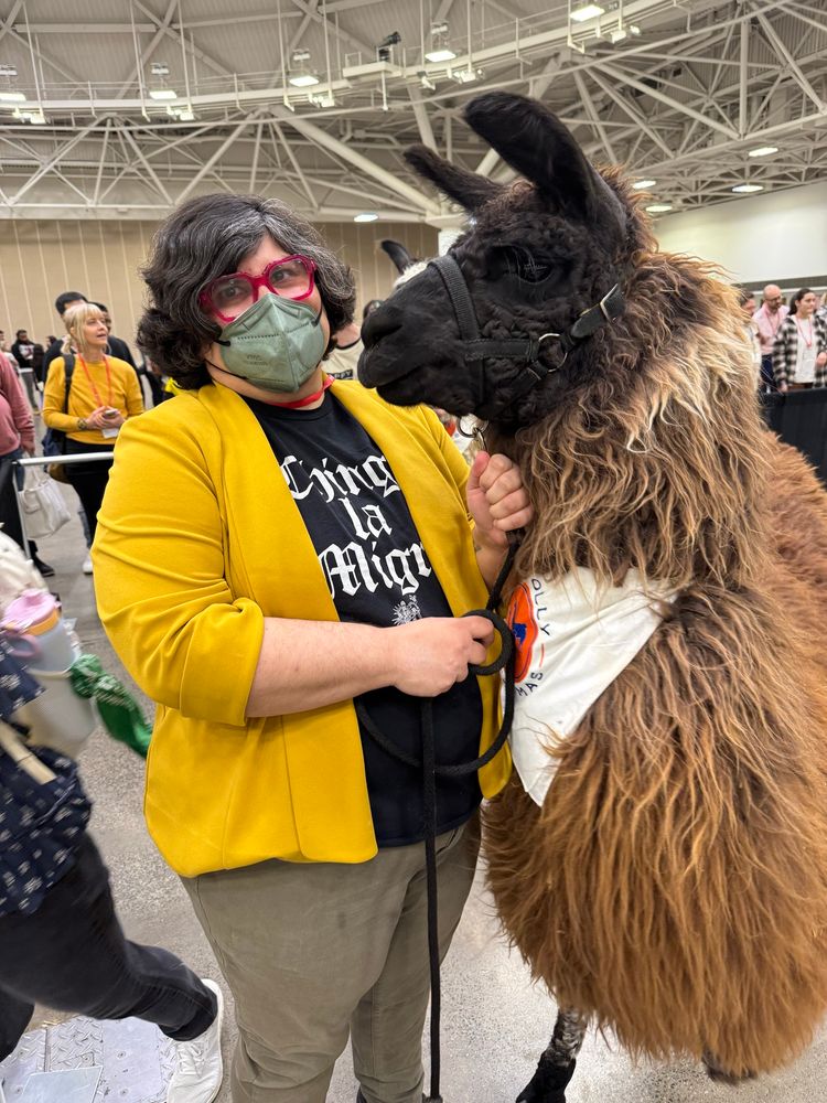 Ceema with a grumpy llama at the MSSA conference. 
