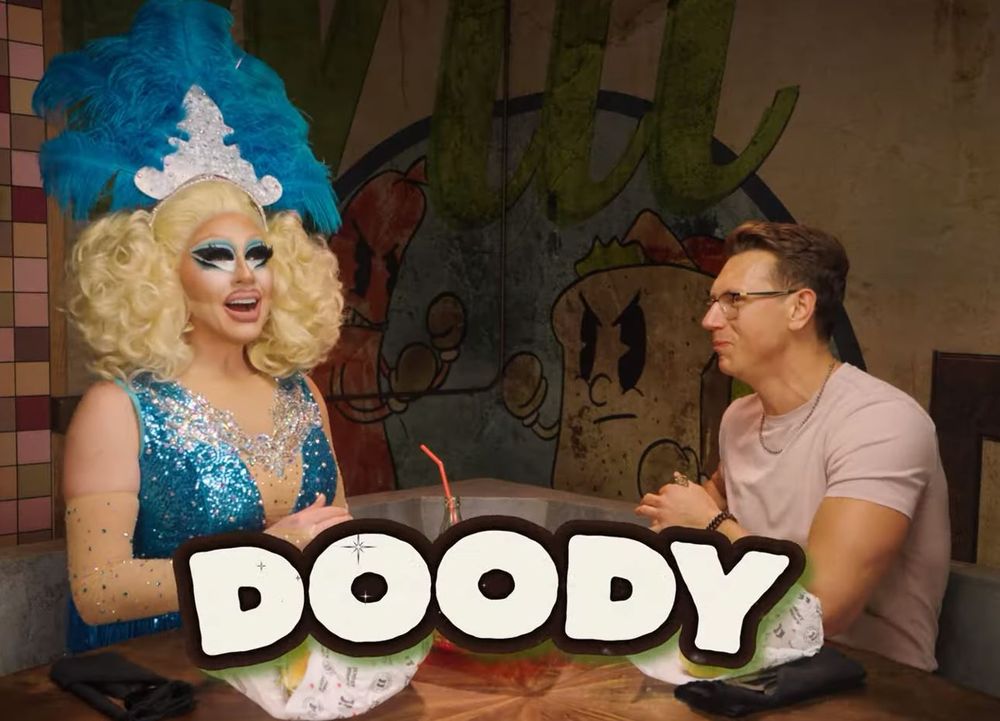 Trixie Mattel and Josh Scherer with the word "DOODY" superimposed in large, slightly clownish letters