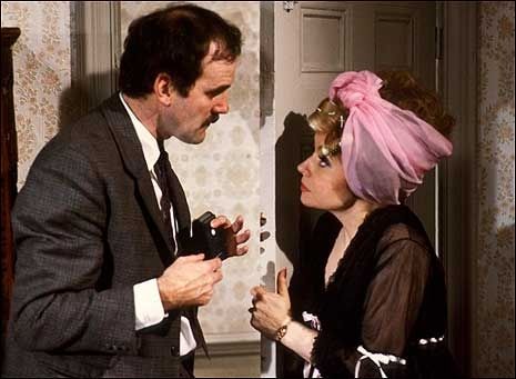 Basil and Sybil having a row outside the bedroom.