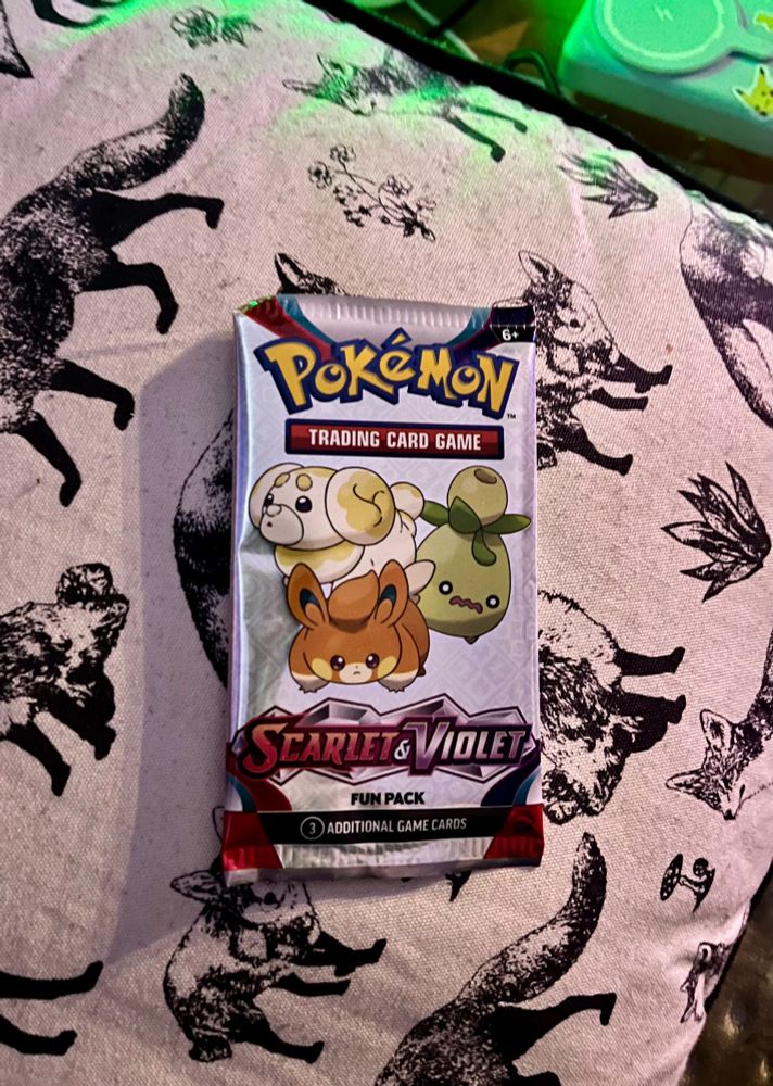 Scarlet and violet fun pack wrapper, it features, Fidough, Pawmi and Smoliv