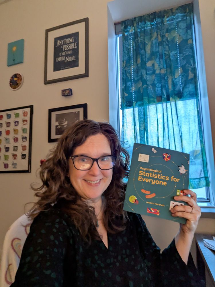 A very happy Jess Hartnett with a sample copy her her brand new text book, Psychological Statistics for Everyone.