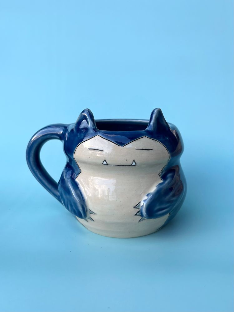 Snorlax pokemon ceramic character mug. Snorlax is the mug, and has sculpted ears and arms attached to the body. 