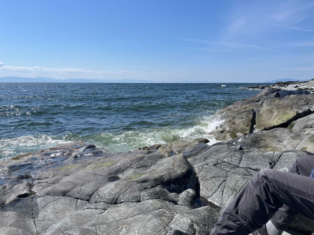 Waves breaking against a large rock