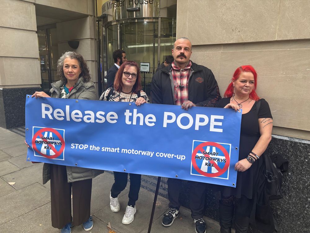 Campaigners hold up a banner outside the DfT